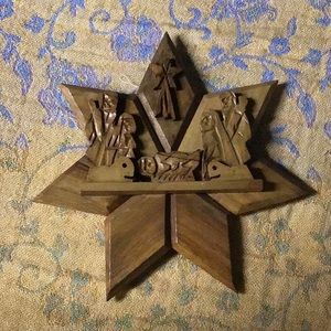 Carved wooden star with manger scene.